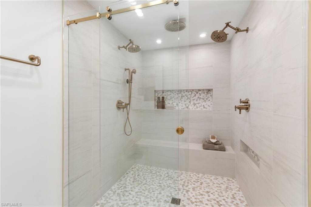 6804 Sand Pointe Circle Naples, FL 34108 - Photo 31 of 49 Massive primary shower featuring porcelain tile, with recess and accent stone, finished with rose-gold fixtures