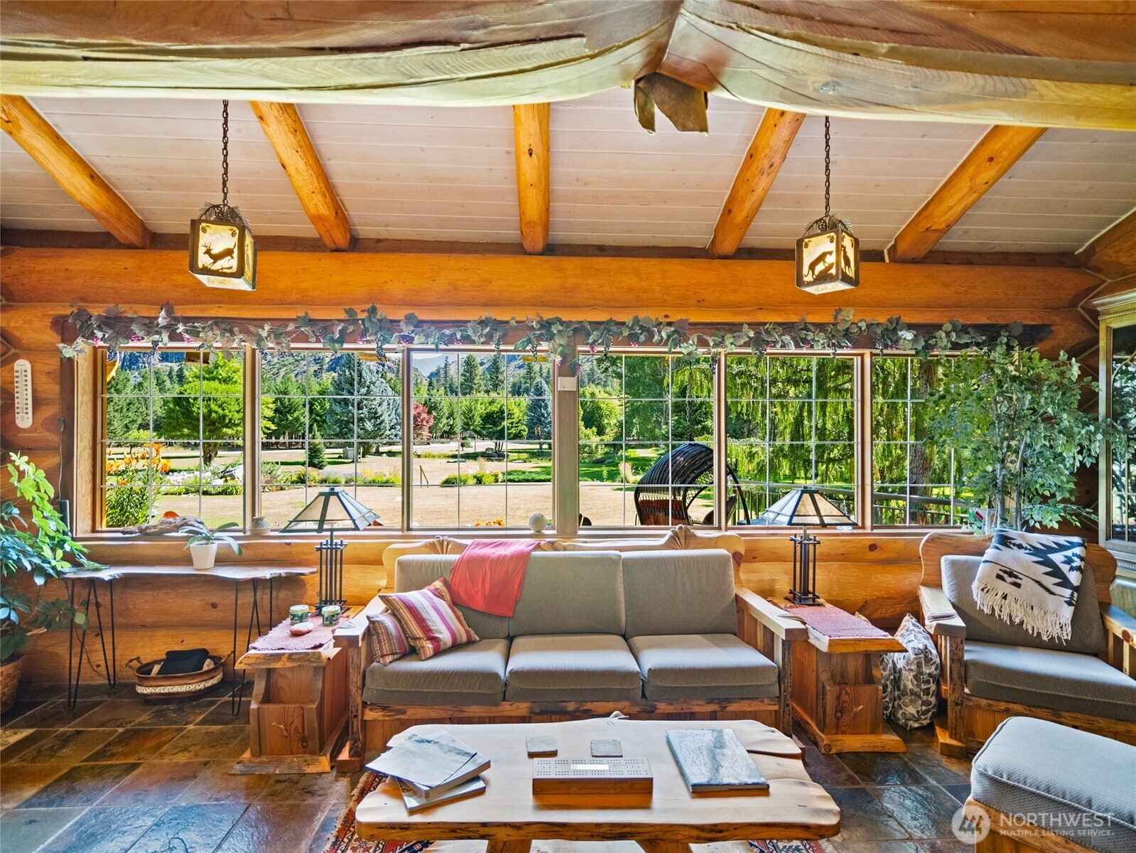 13537 Entiat River Road Entiat, WA 98822 - Photo 6 of 40 a living room with patio furniture and a floor to ceiling window