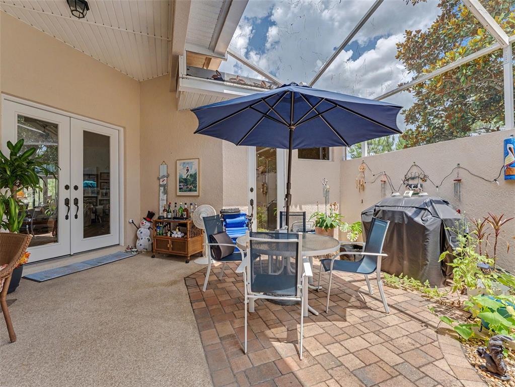8910 Jericho Road Weeki Wachee, FL 34613 - Photo 14 of 52 a view of a patio with a table and chairs under an umbrella