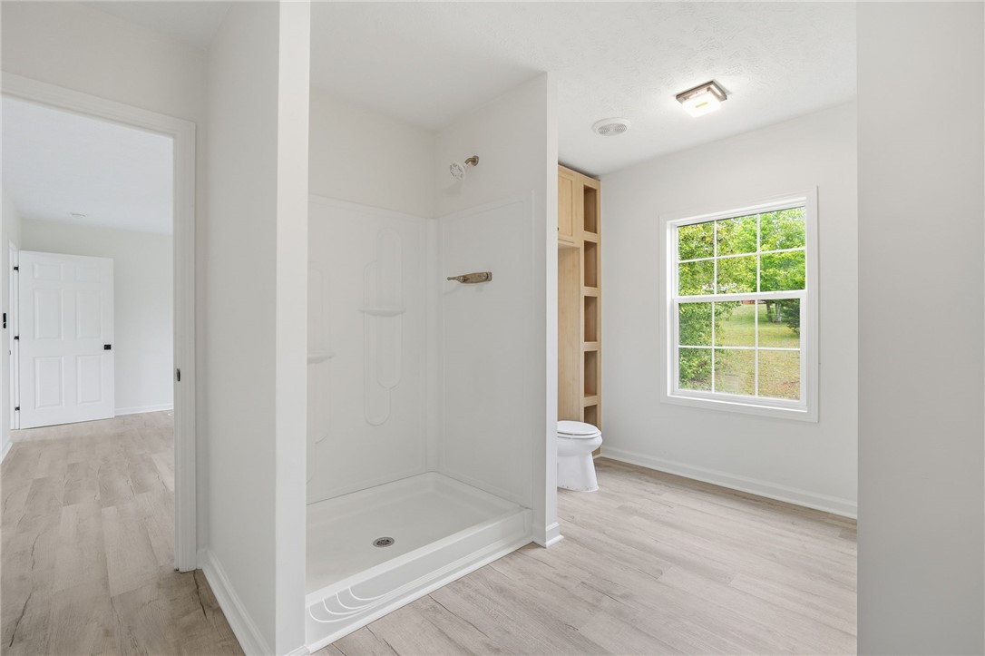 112 Sir Francis Drake Way Liberty, SC 29657 - Photo 39 of 42 This bright bathroom features a convenient shower, ample natural light, and modern wood-look flooring.