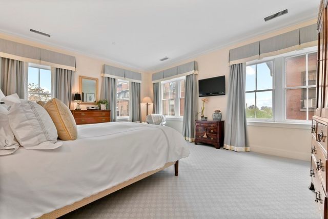 a bedroom with a large bed and a tv