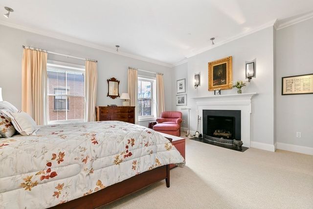 a bedroom with a bed and a fireplace