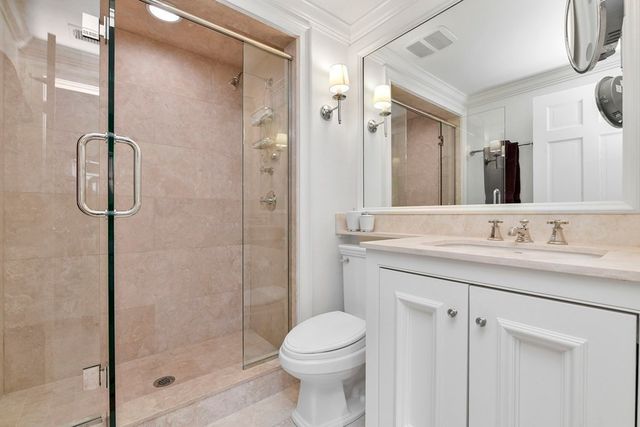 a bathroom with a granite countertop sink toilet and shower