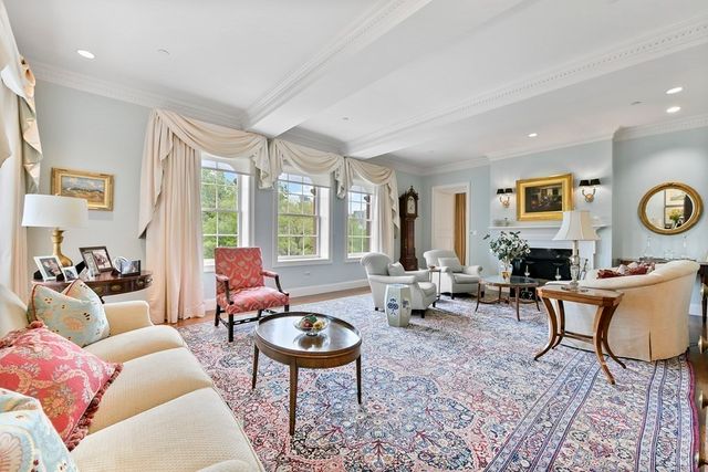 a living room with furniture couches and a large window