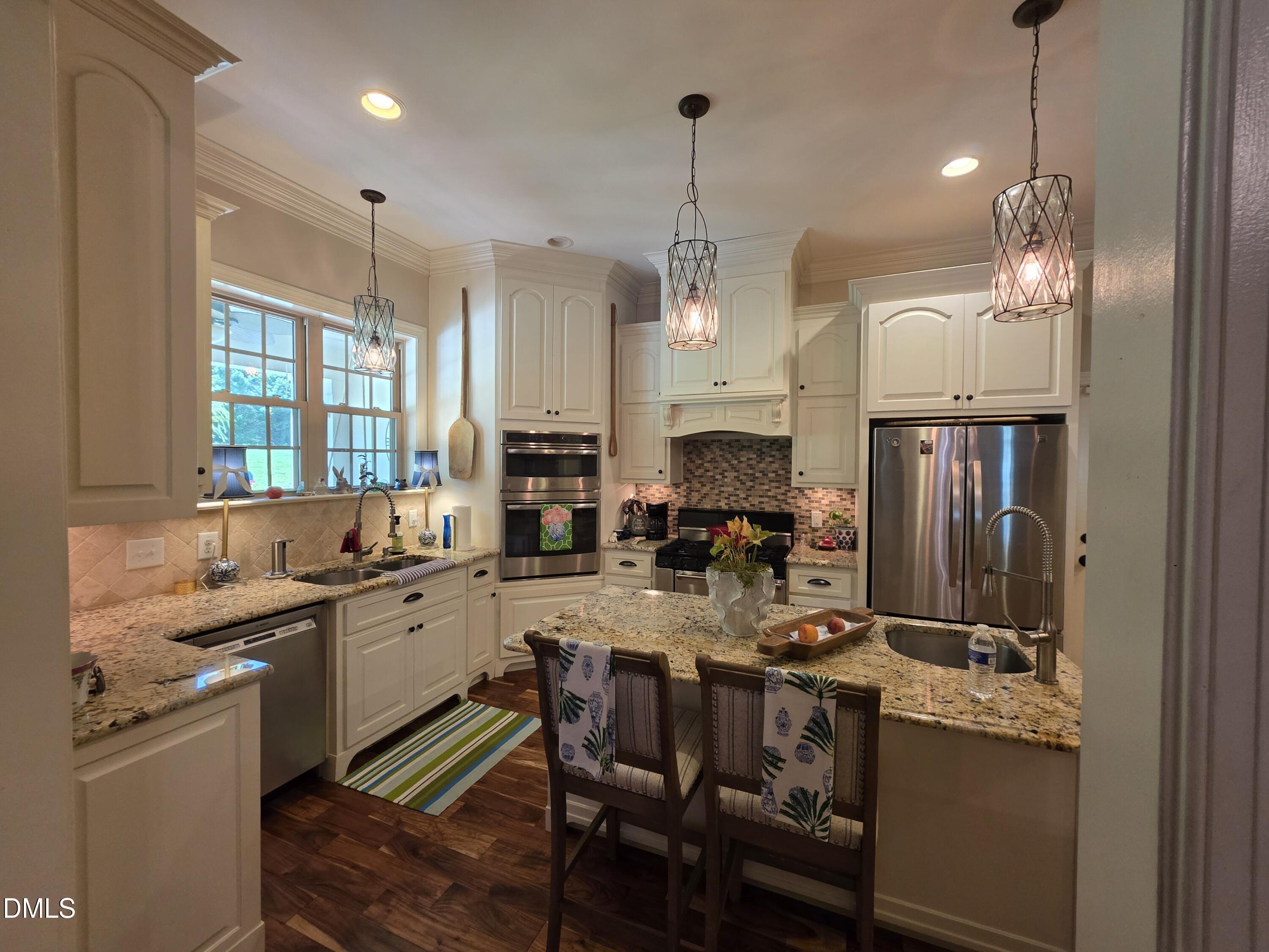 413 Johnson Town Road Zebulon, NC 27597 - Photo 14 of 42 a kitchen with sink refrigerator and cabinets