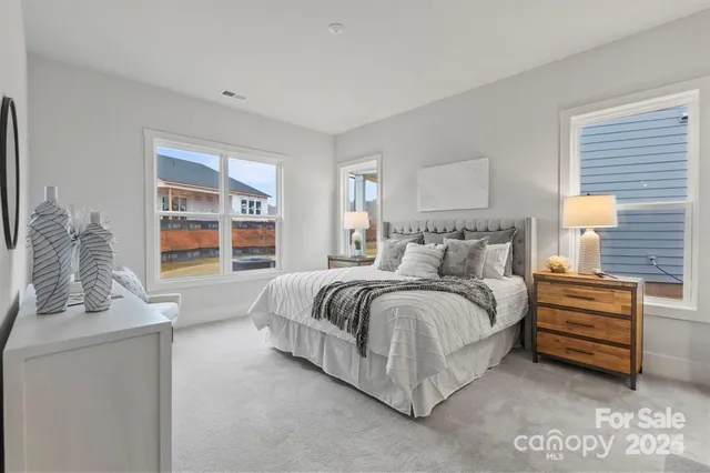 a spacious bedroom with a bed and a window