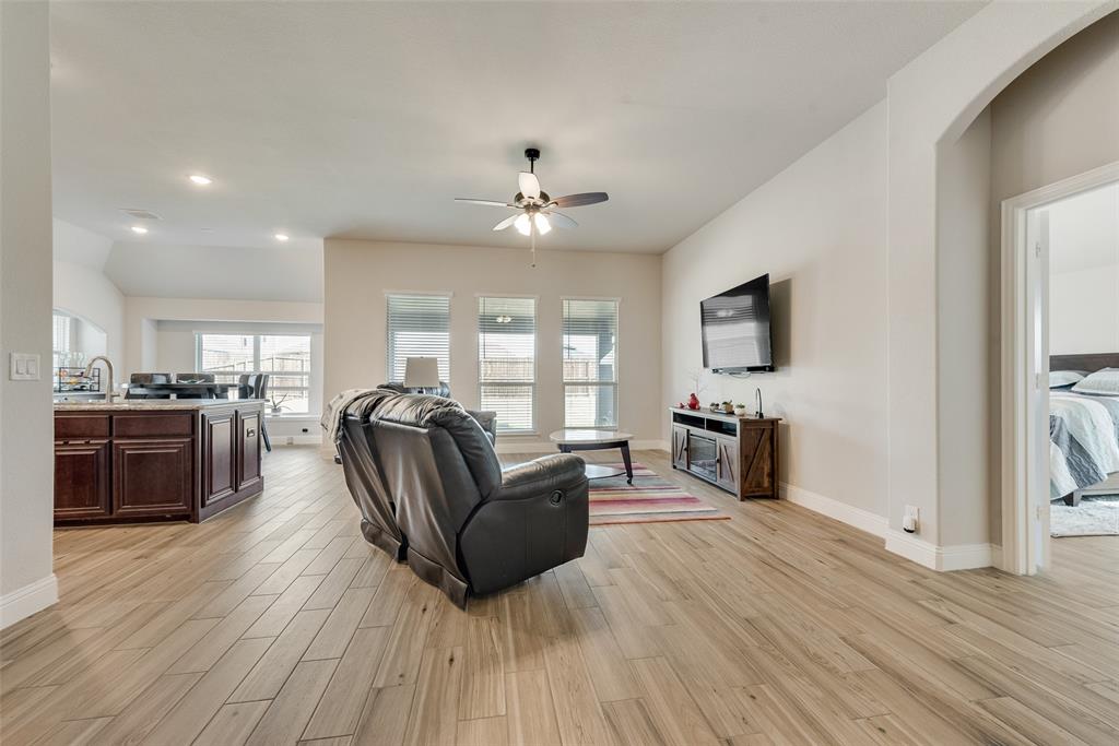 2010 Dundalk Lane Forney, TX 75126 - Photo 11 of 37 a living room with furniture a fireplace and a flat screen tv