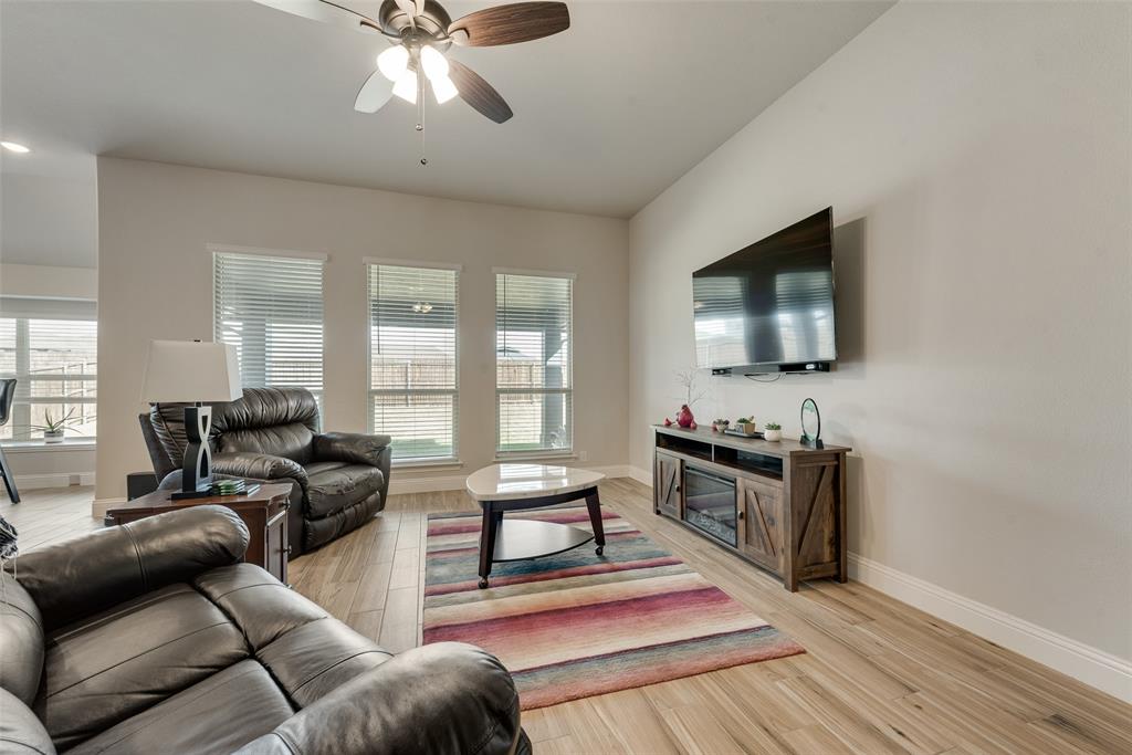 2010 Dundalk Lane Forney, TX 75126 - Photo 12 of 37 a living room with furniture and a flat screen tv