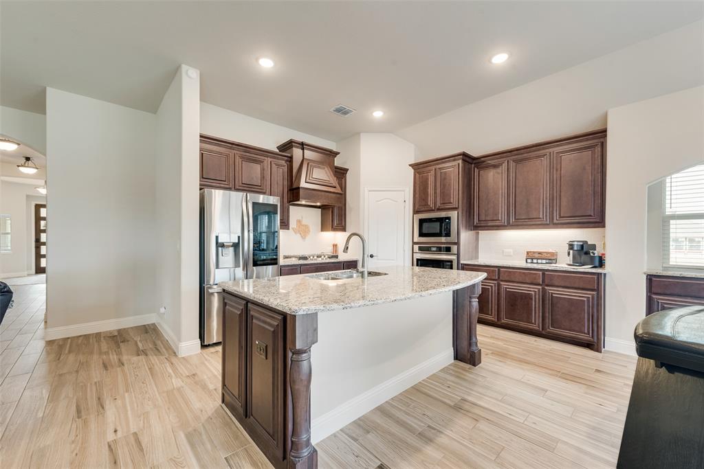 2010 Dundalk Lane Forney, TX 75126 - Photo 18 of 37 a kitchen with stainless steel appliances granite countertop a sink stove and refrigerator