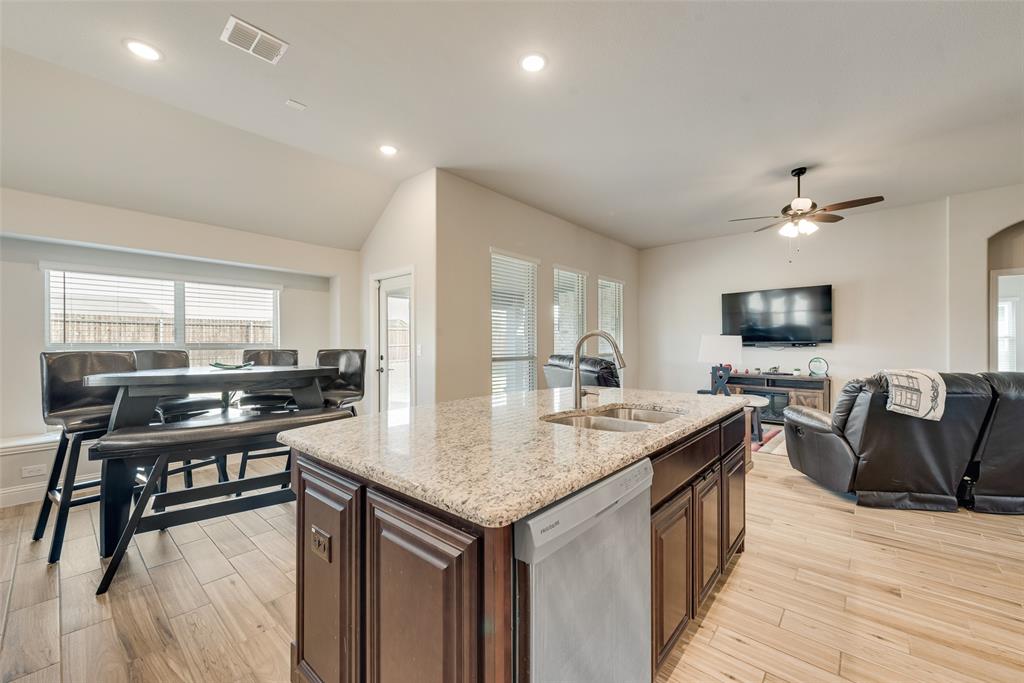 2010 Dundalk Lane Forney, TX 75126 - Photo 19 of 37 a view of a kitchen with kitchen island a sink table and chairs