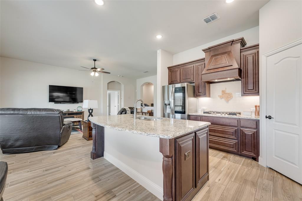 2010 Dundalk Lane Forney, TX 75126 - Photo 20 of 37 a large kitchen with stainless steel appliances a large counter top a stove and a wooden floors