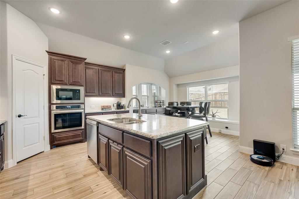 2010 Dundalk Lane Forney, TX 75126 - Photo 21 of 37 a kitchen with stainless steel appliances granite countertop a sink stove and refrigerator