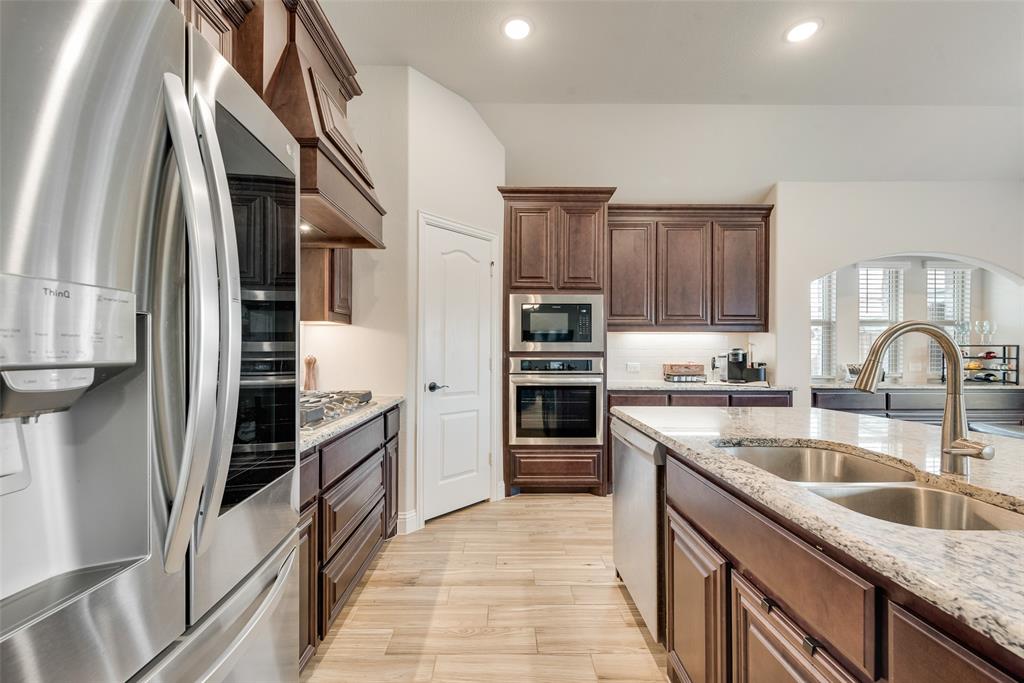2010 Dundalk Lane Forney, TX 75126 - Photo 22 of 37 a kitchen with stainless steel appliances granite countertop a refrigerator and a sink