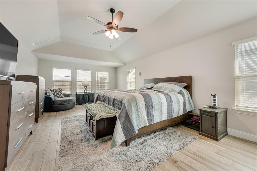 2010 Dundalk Lane Forney, TX 75126 - Photo 24 of 37 a bedroom with a large bed and a chandelier