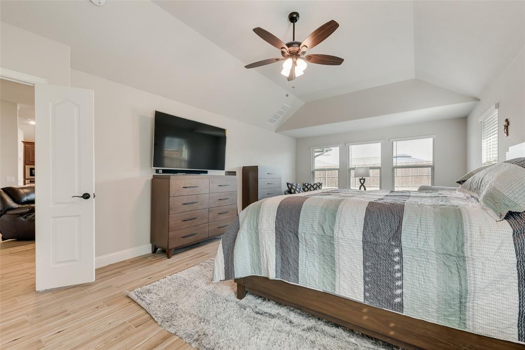 2010 Dundalk Lane Forney, TX 75126 - Photo 26 of 37 a spacious bedroom with a bed and a flat screen tv