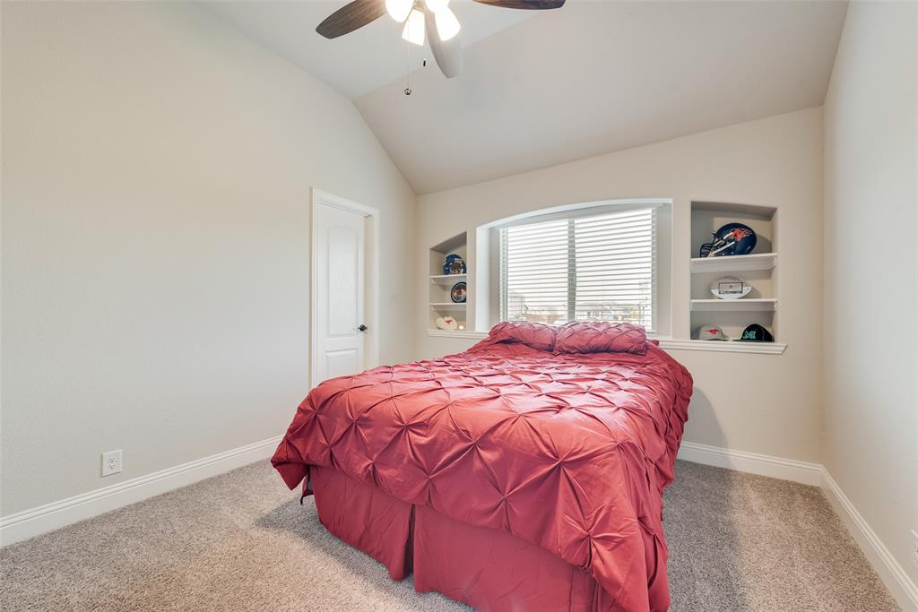 2010 Dundalk Lane Forney, TX 75126 - Photo 30 of 37 a bedroom with a bed and a chandelier