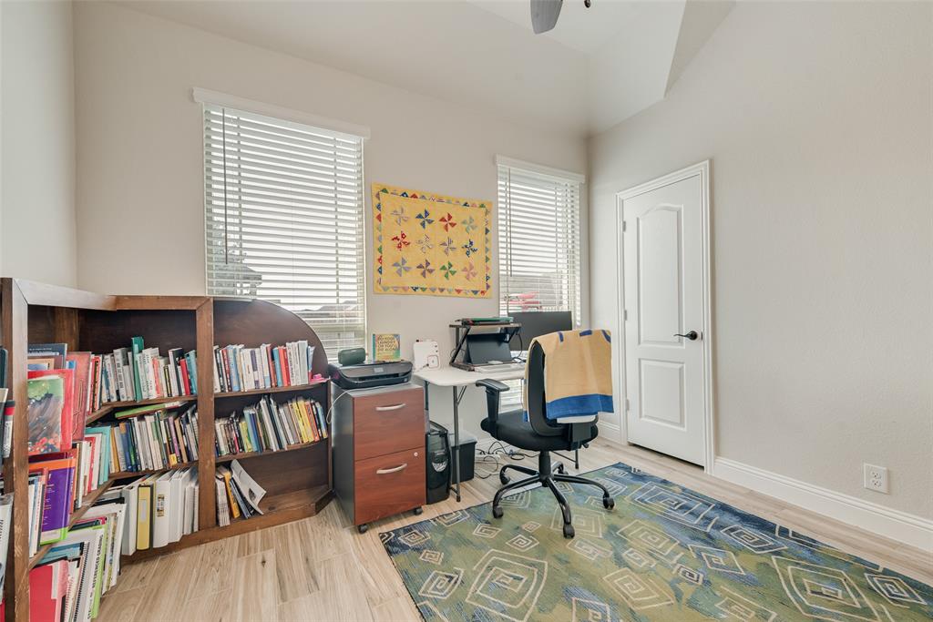 2010 Dundalk Lane Forney, TX 75126 - Photo 34 of 37 a view of a workspace with furniture and a book shelf