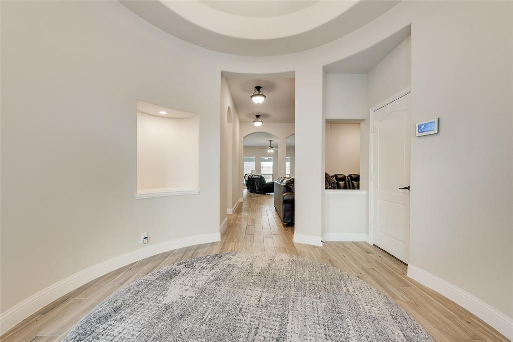 2010 Dundalk Lane Forney, TX 75126 - Photo 8 of 37 a view of a hallway with wooden floor and a living room