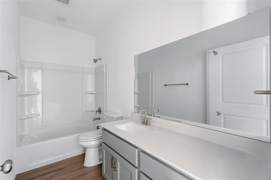 1203 Doris May Drive Allen, TX 75013 - Photo 13 of 35 a bathroom with a sink a toilet and shower