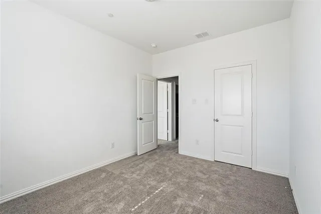 a kitchen with stainless steel appliances granite countertop a stove a sink dishwasher and a refrigerator with wooden floor