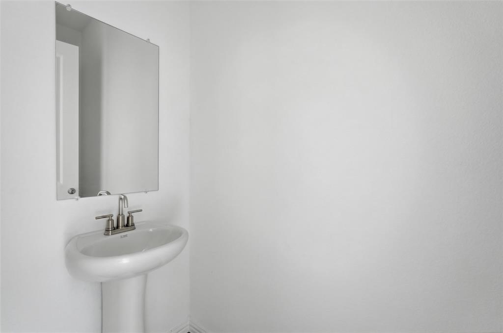 1203 Doris May Drive Allen, TX 75013 - Photo 18 of 35 a bathroom with a sink and a mirror