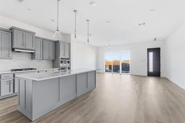 a view of a kitchen with wooden floor