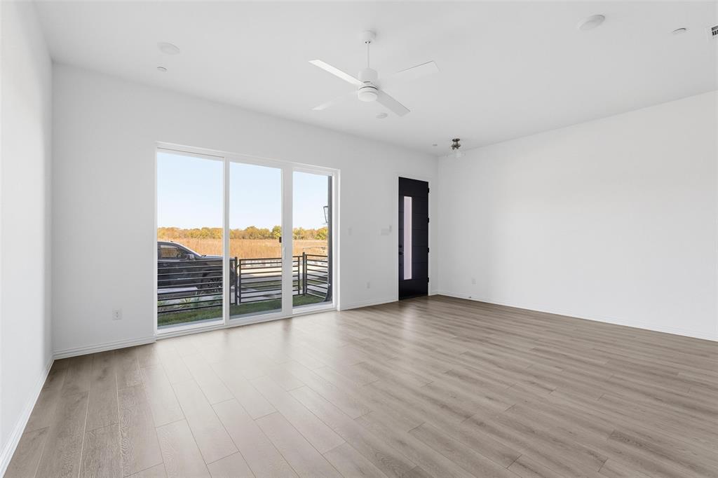 1203 Doris May Drive Allen, TX 75013 - Photo 22 of 35 an empty room with wooden floor and windows