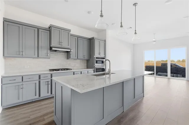 a kitchen with granite countertop a stove and a sink