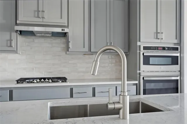 a kitchen with a sink a counter space and wooden floor