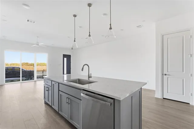 a metallic refrigerator freezer sitting in a kitchen