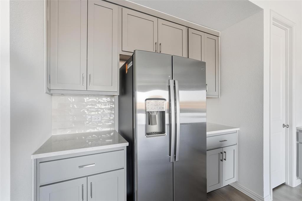 1203 Doris May Drive Allen, TX 75013 - Photo 30 of 35 a metallic refrigerator freezer sitting in a kitchen