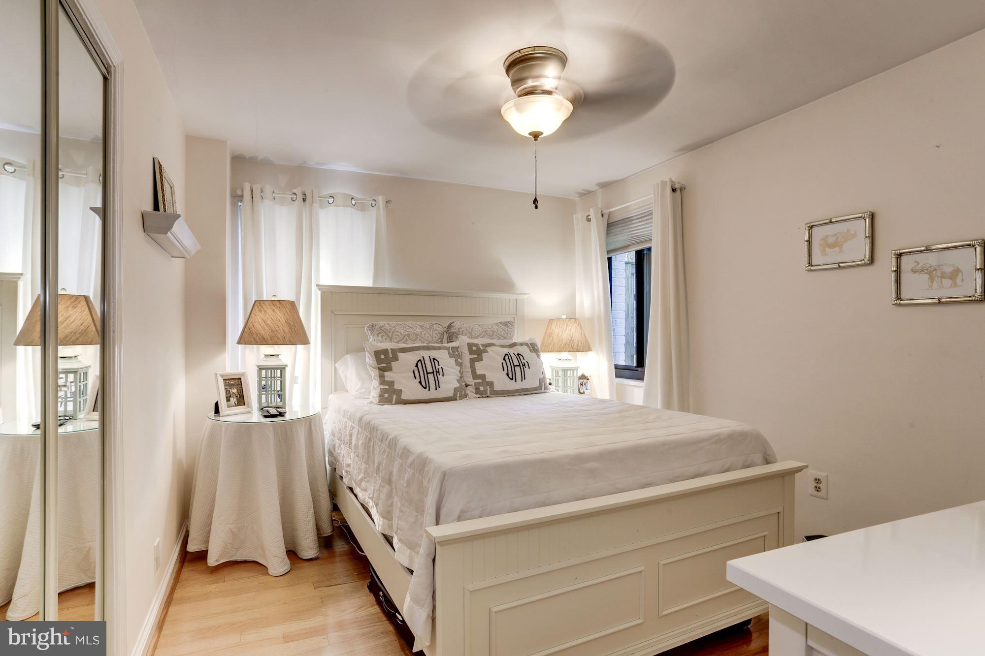 2604 Tunlaw Road Northwest, Unit 2 Washington, DC 20007 - Photo 13 of 25 a bedroom with a bed and a chandelier