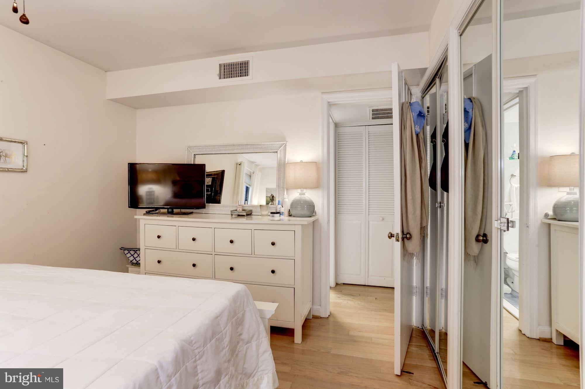 2604 Tunlaw Road Northwest, Unit 2 Washington, DC 20007 - Photo 15 of 25 a bedroom with a bed and flat screen tv
