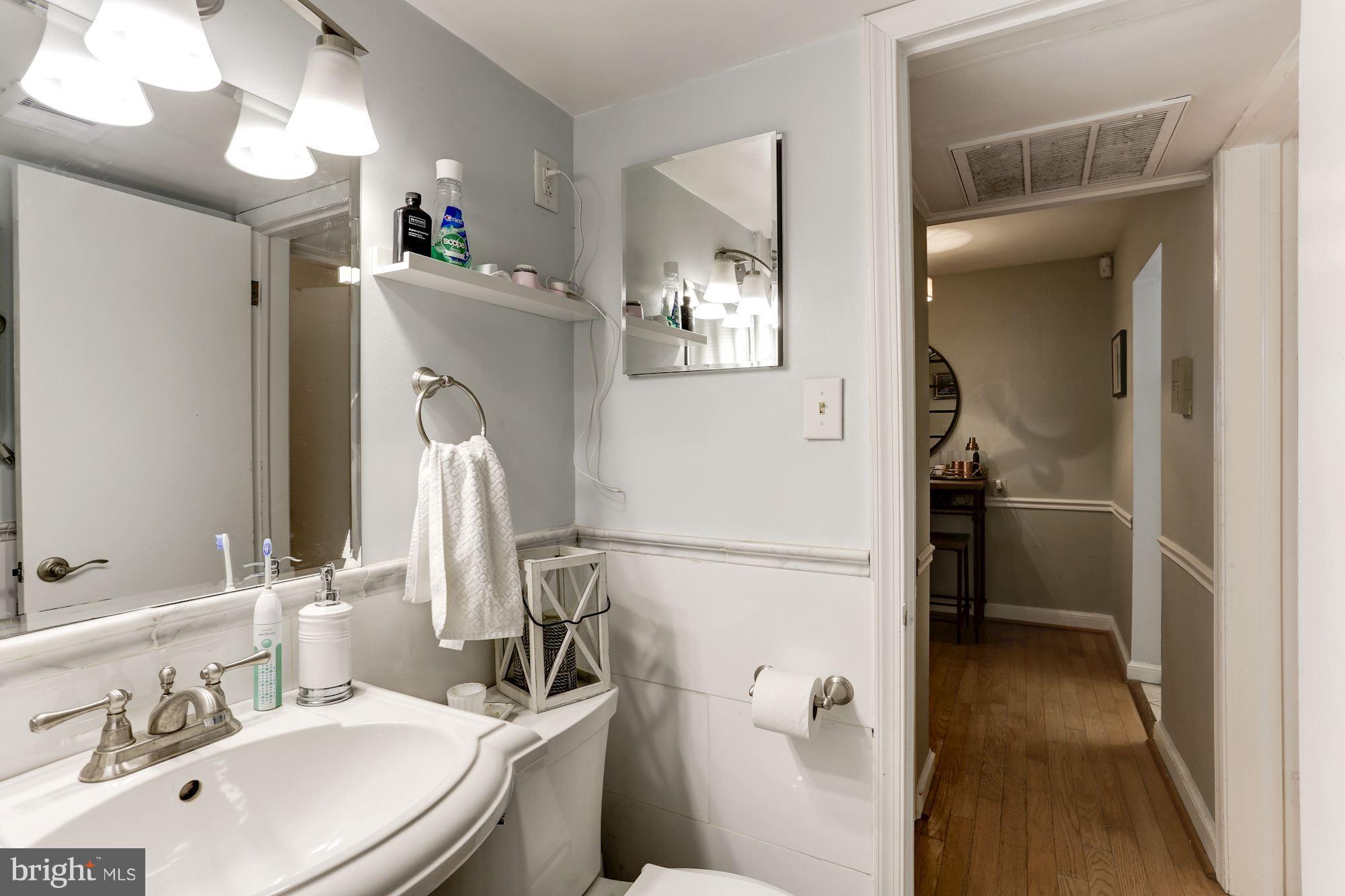2604 Tunlaw Road Northwest, Unit 2 Washington, DC 20007 - Photo 19 of 25 a bathroom with a sink a toilet and shower