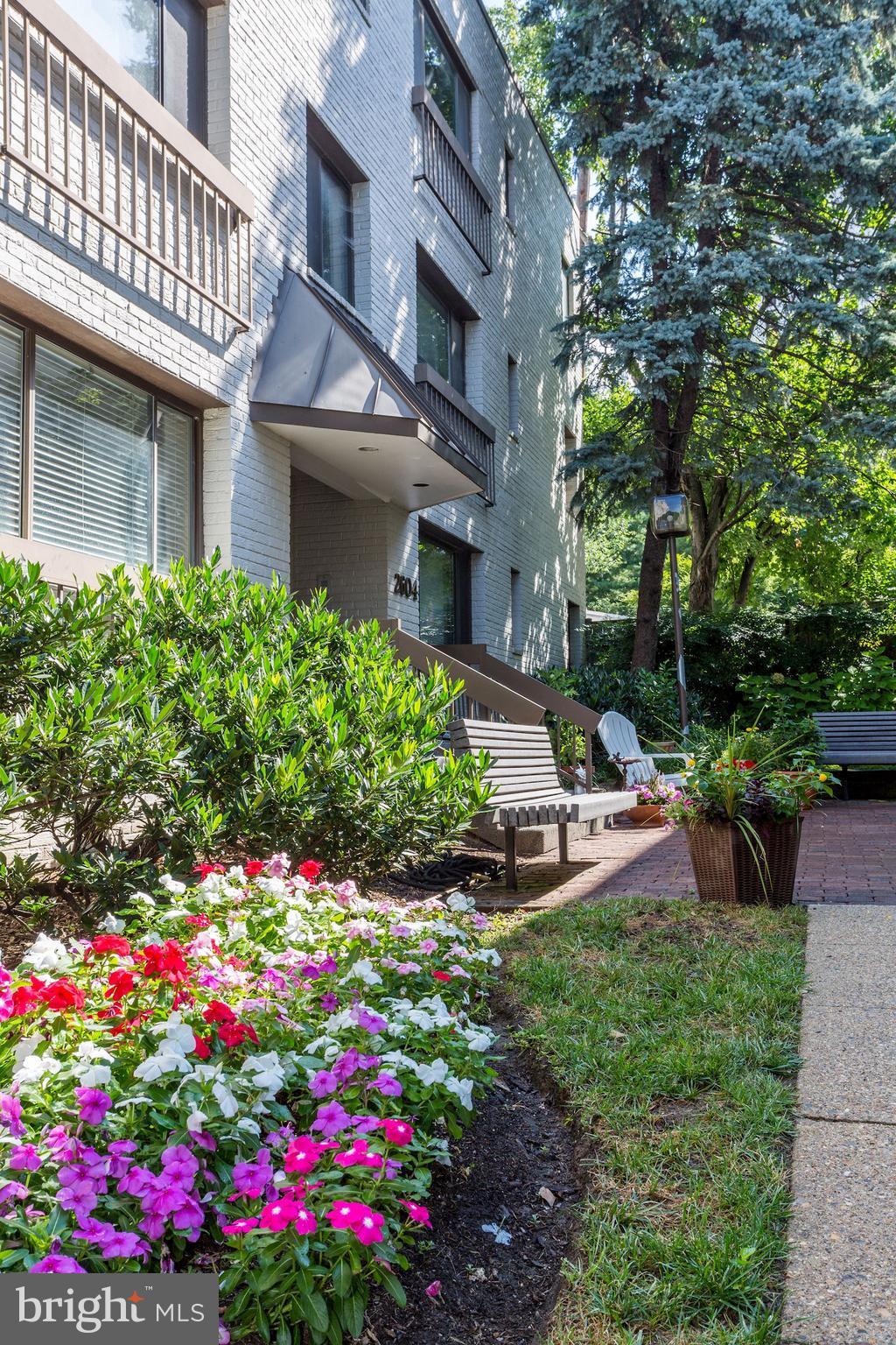 2604 Tunlaw Road Northwest, Unit 2 Washington, DC 20007 - Photo 22 of 25 a view of a house with a big yard and flower plants