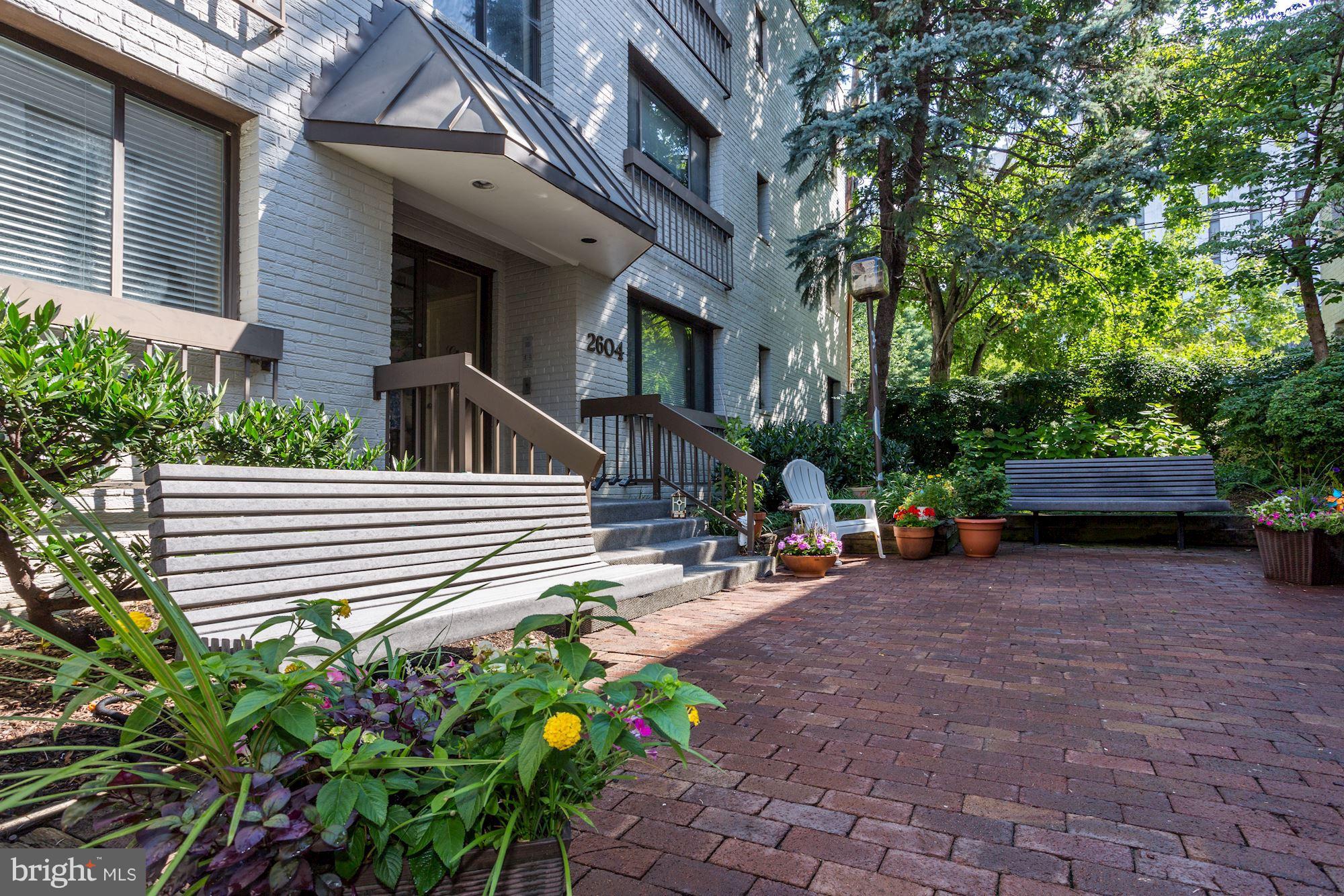2604 Tunlaw Road Northwest, Unit 2 Washington, DC 20007 - Photo 23 of 25 a view of a house with a small yard and sitting area
