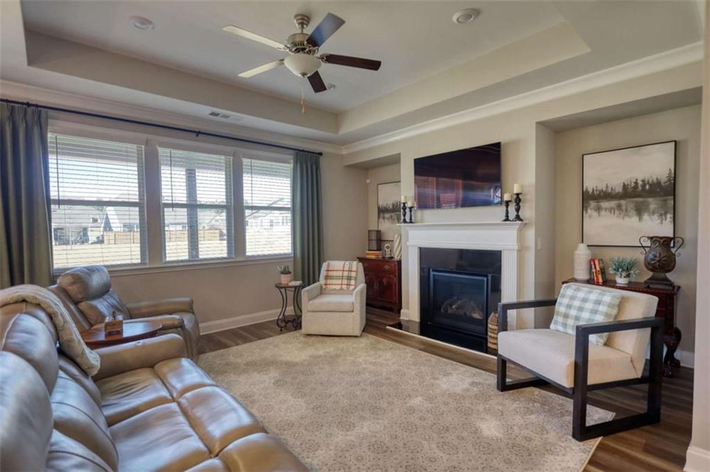479 Glenmont Road Grayson, GA 30017 - Photo 21 of 58 a living room with furniture a flat screen tv and a fireplace
