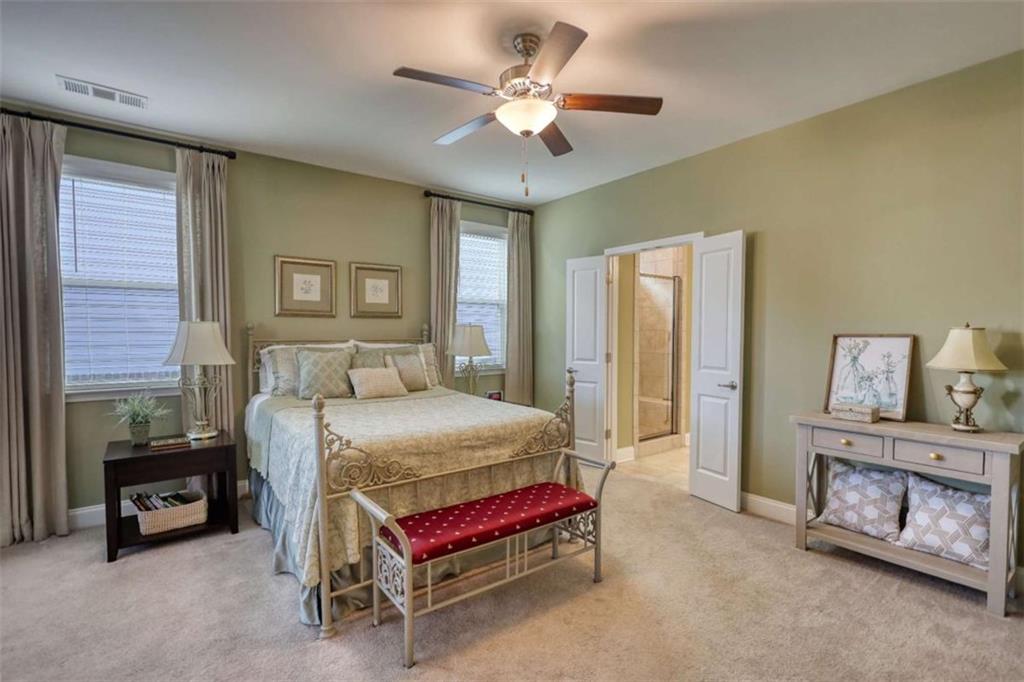 479 Glenmont Road Grayson, GA 30017 - Photo 24 of 58 a bedroom with a bed and a chandelier