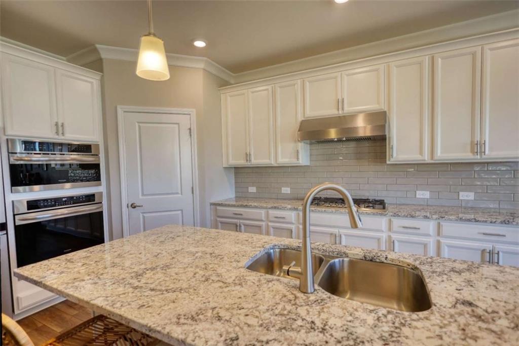 479 Glenmont Road Grayson, GA 30017 - Photo 25 of 58 a kitchen with stainless steel appliances granite countertop a sink stove and refrigerator