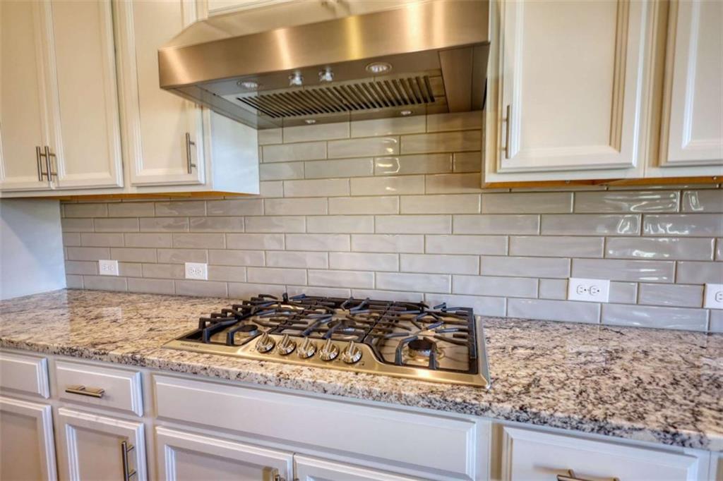 479 Glenmont Road Grayson, GA 30017 - Photo 28 of 58 a kitchen with granite countertop white cabinets and a stove