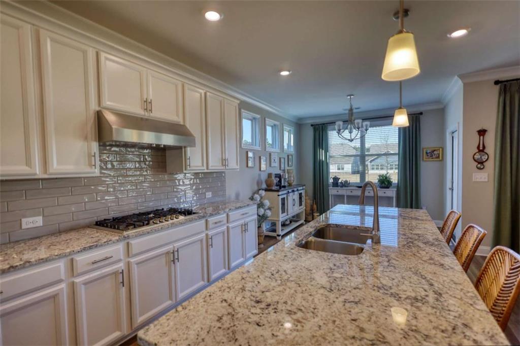 479 Glenmont Road Grayson, GA 30017 - Photo 30 of 58 a kitchen with stainless steel appliances granite countertop a stove sink and cabinets