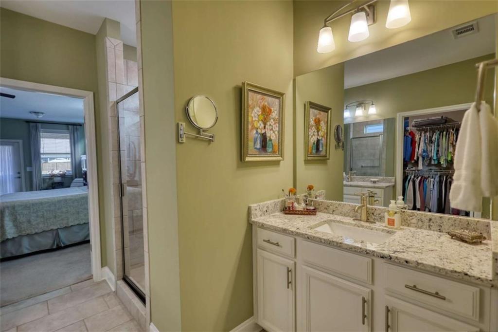 479 Glenmont Road Grayson, GA 30017 - Photo 32 of 58 a bathroom with a double vanity sink and a mirror