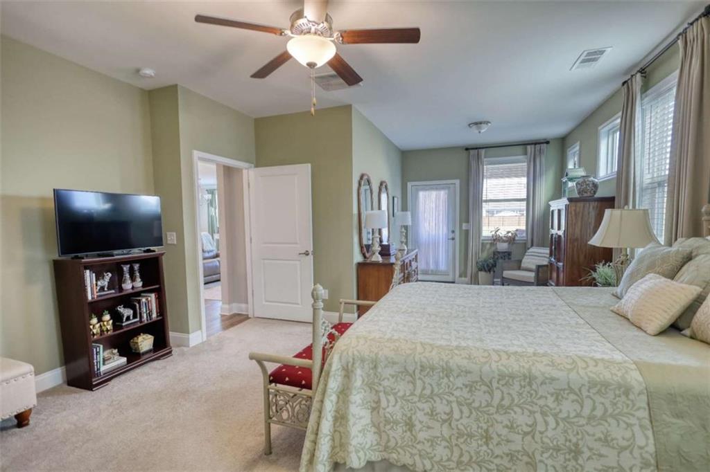 479 Glenmont Road Grayson, GA 30017 - Photo 34 of 58 a spacious bedroom with a bed and a flat screen tv