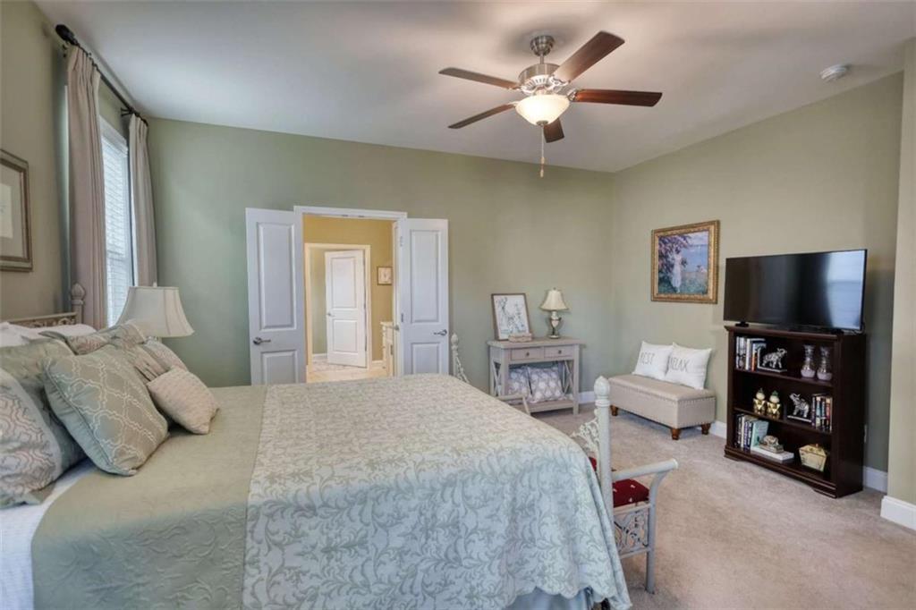 479 Glenmont Road Grayson, GA 30017 - Photo 36 of 58 a bedroom with a bed and a flat screen tv