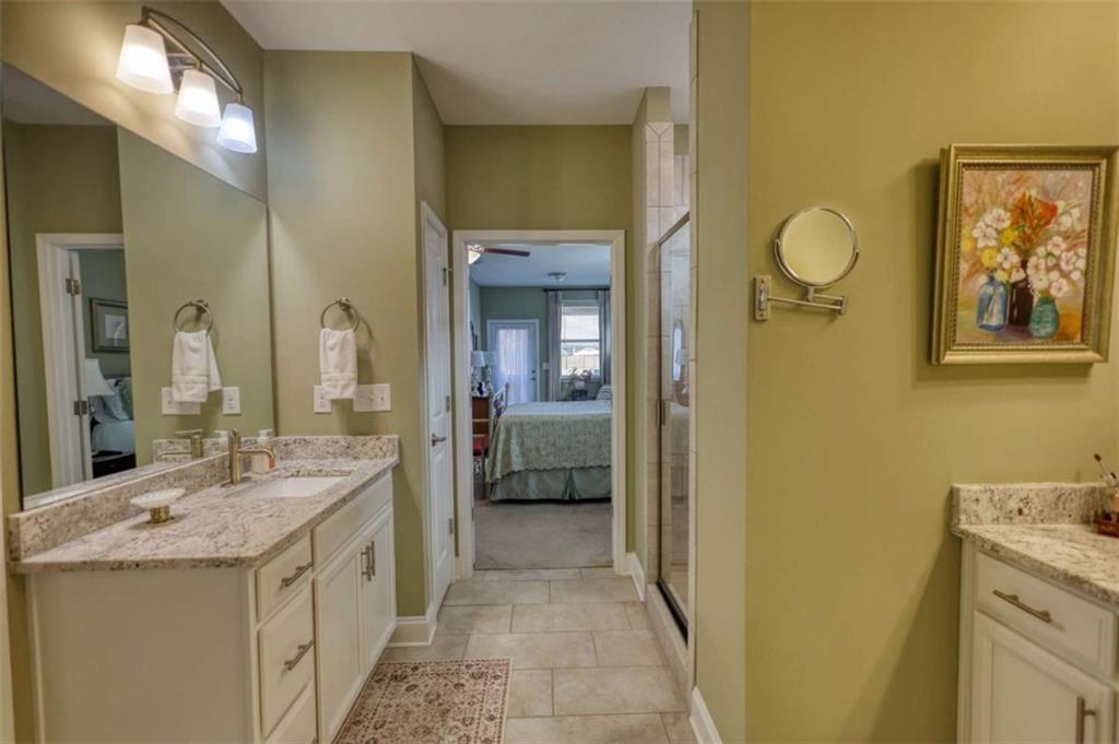 479 Glenmont Road Grayson, GA 30017 - Photo 38 of 58 a en suite bathroom with a granite countertop sink and a mirror