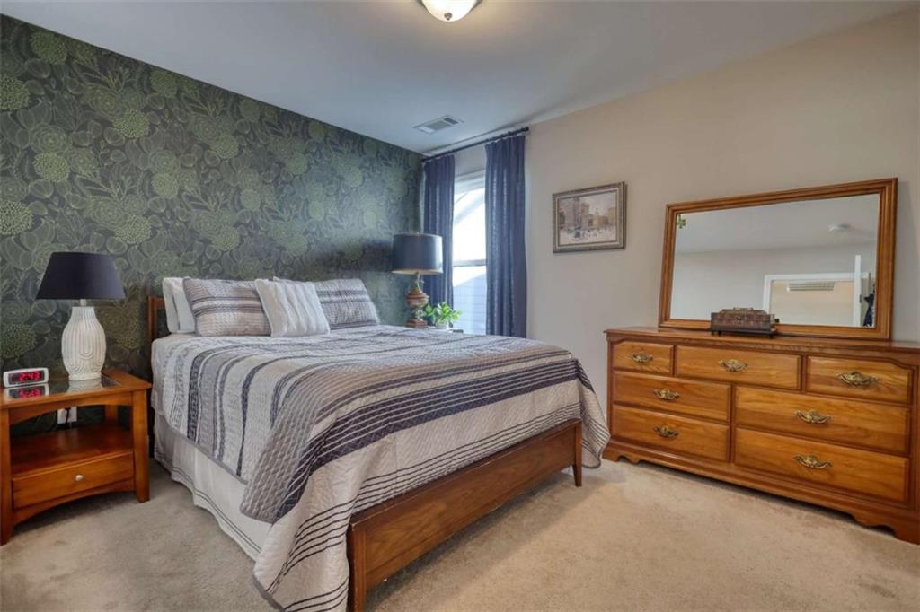 479 Glenmont Road Grayson, GA 30017 - Photo 39 of 58 a bedroom with a bed and a dresser in it