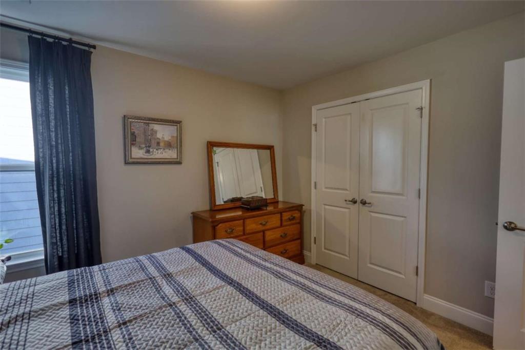 479 Glenmont Road Grayson, GA 30017 - Photo 41 of 58 a bedroom with a bed and a painting on the wall