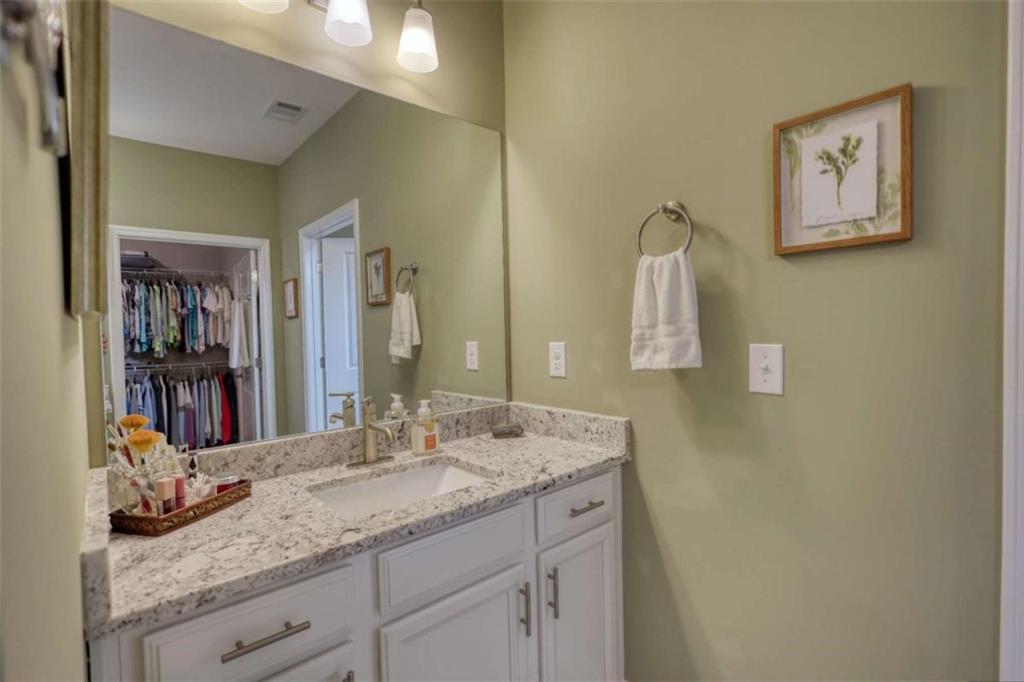 479 Glenmont Road Grayson, GA 30017 - Photo 42 of 58 a bathroom with a granite countertop sink and a mirror