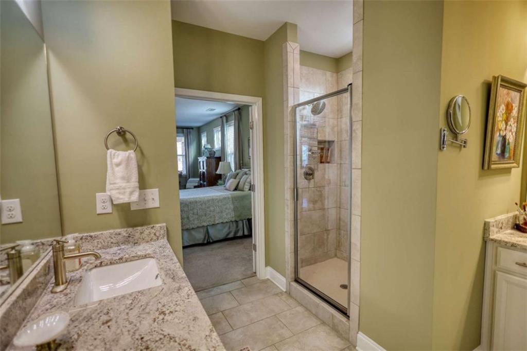 479 Glenmont Road Grayson, GA 30017 - Photo 45 of 58 a en suite bathroom with a granite countertop sink and a mirror