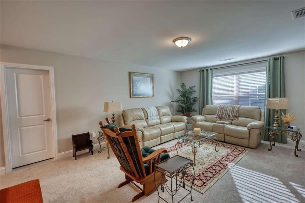 479 Glenmont Road Grayson, GA 30017 - Photo 48 of 58 a living room with furniture and a window
